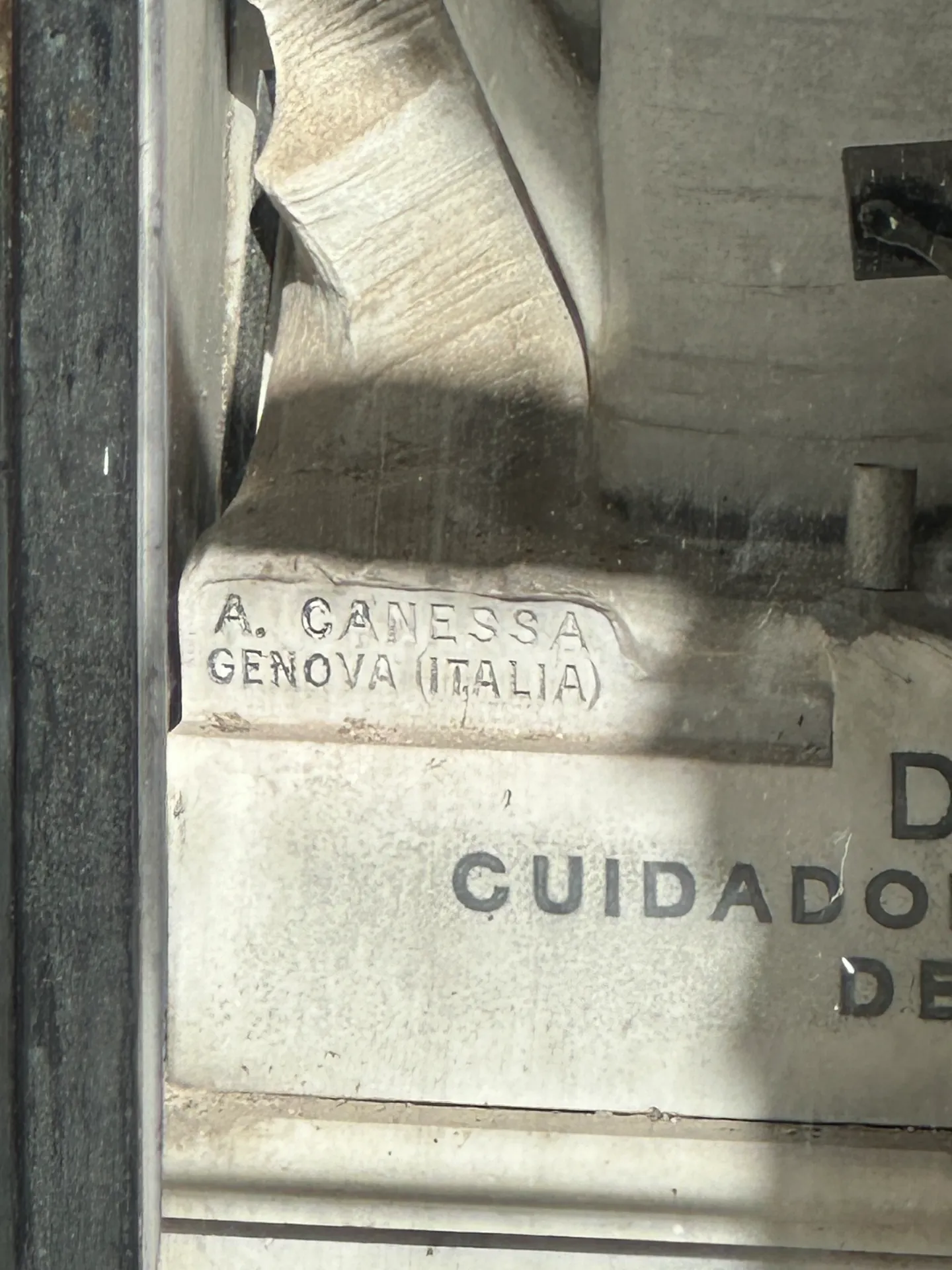 The sculptor's signature A. Canessa, Genova, Italia carved into the marble of the Alleno tomb.