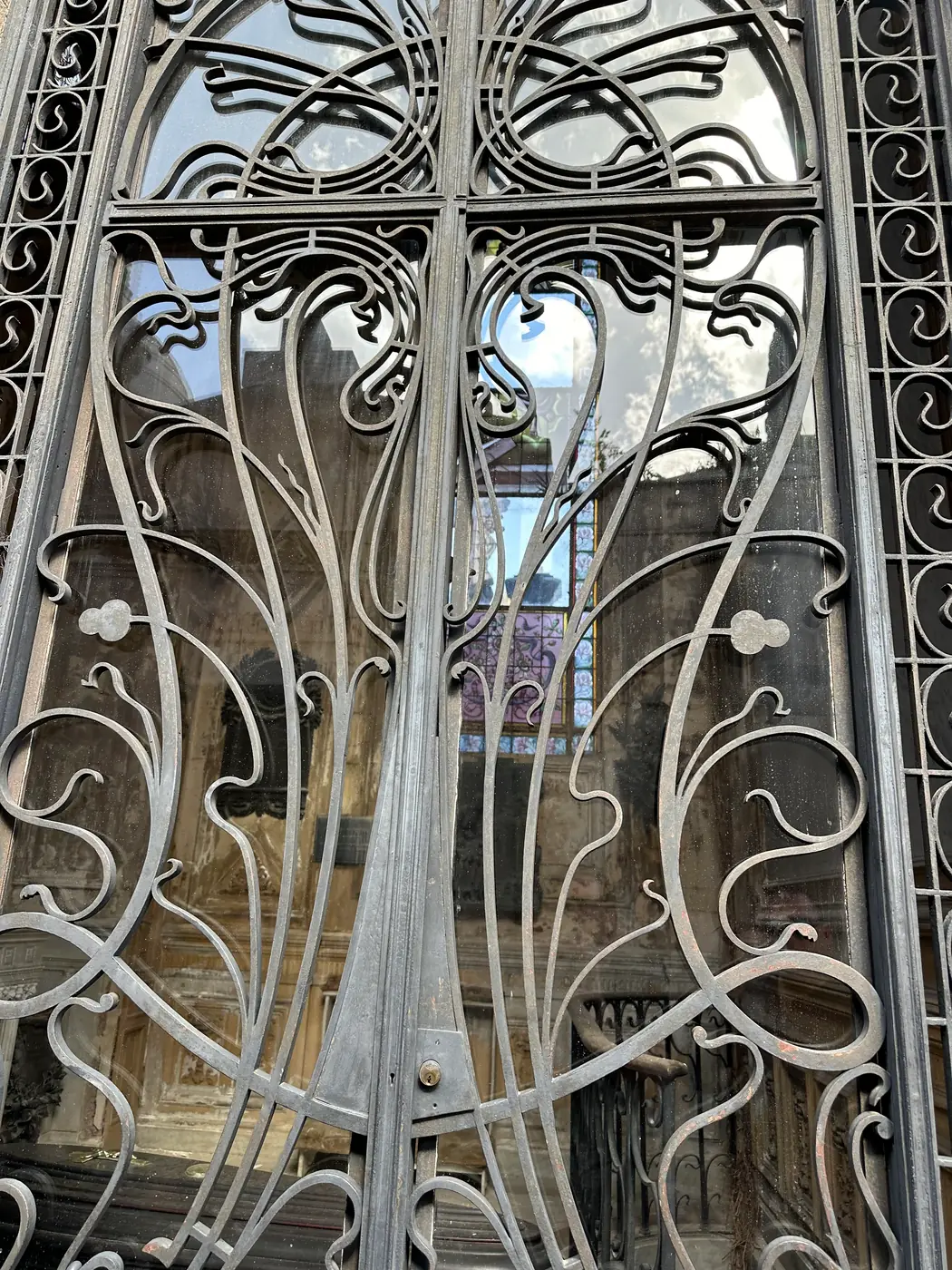 An art nouveau wrought-iron mausoleum door with whiplash curves.