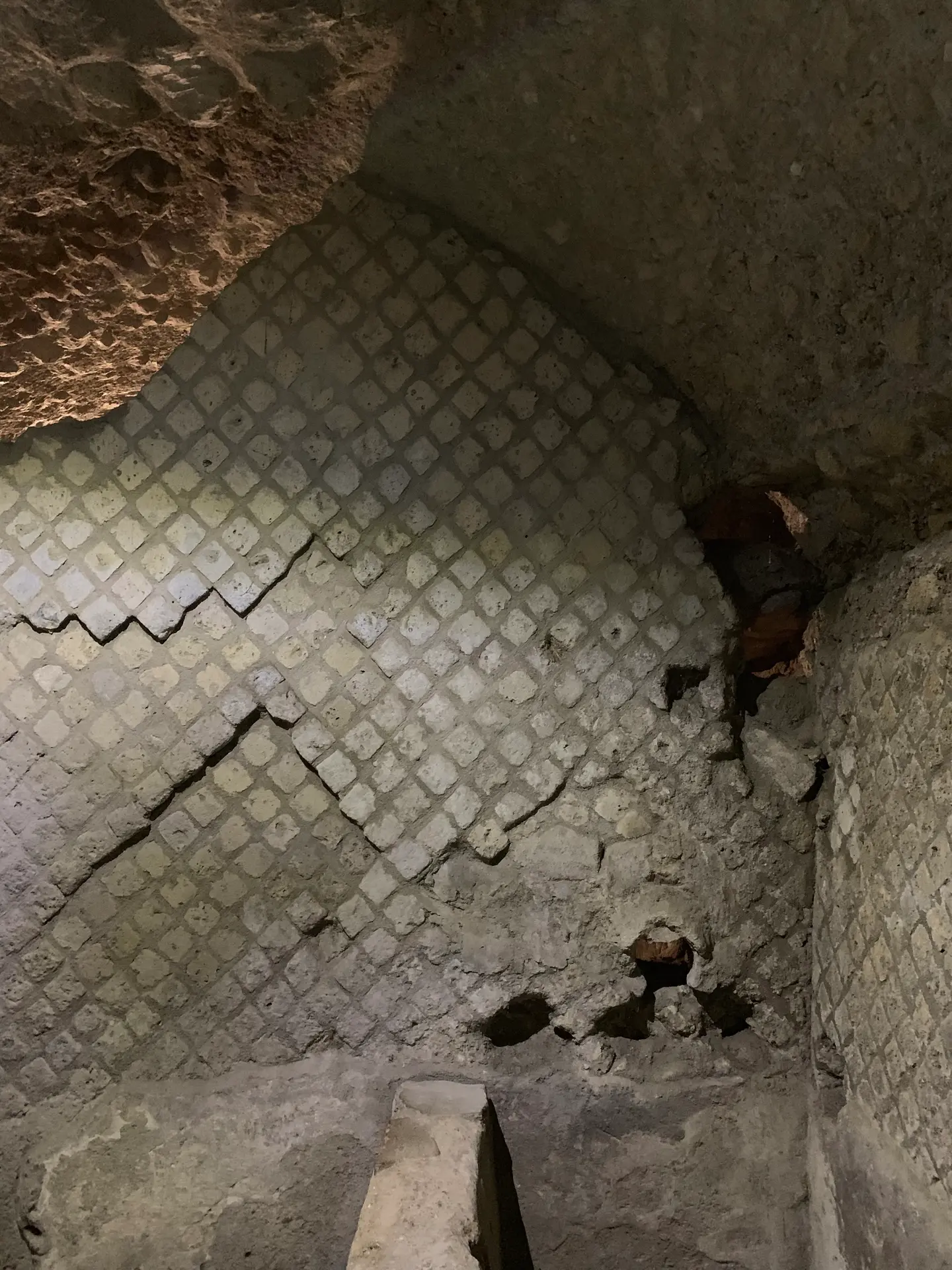 Roman reticulate stonework with brick courses running through it, in Naples.