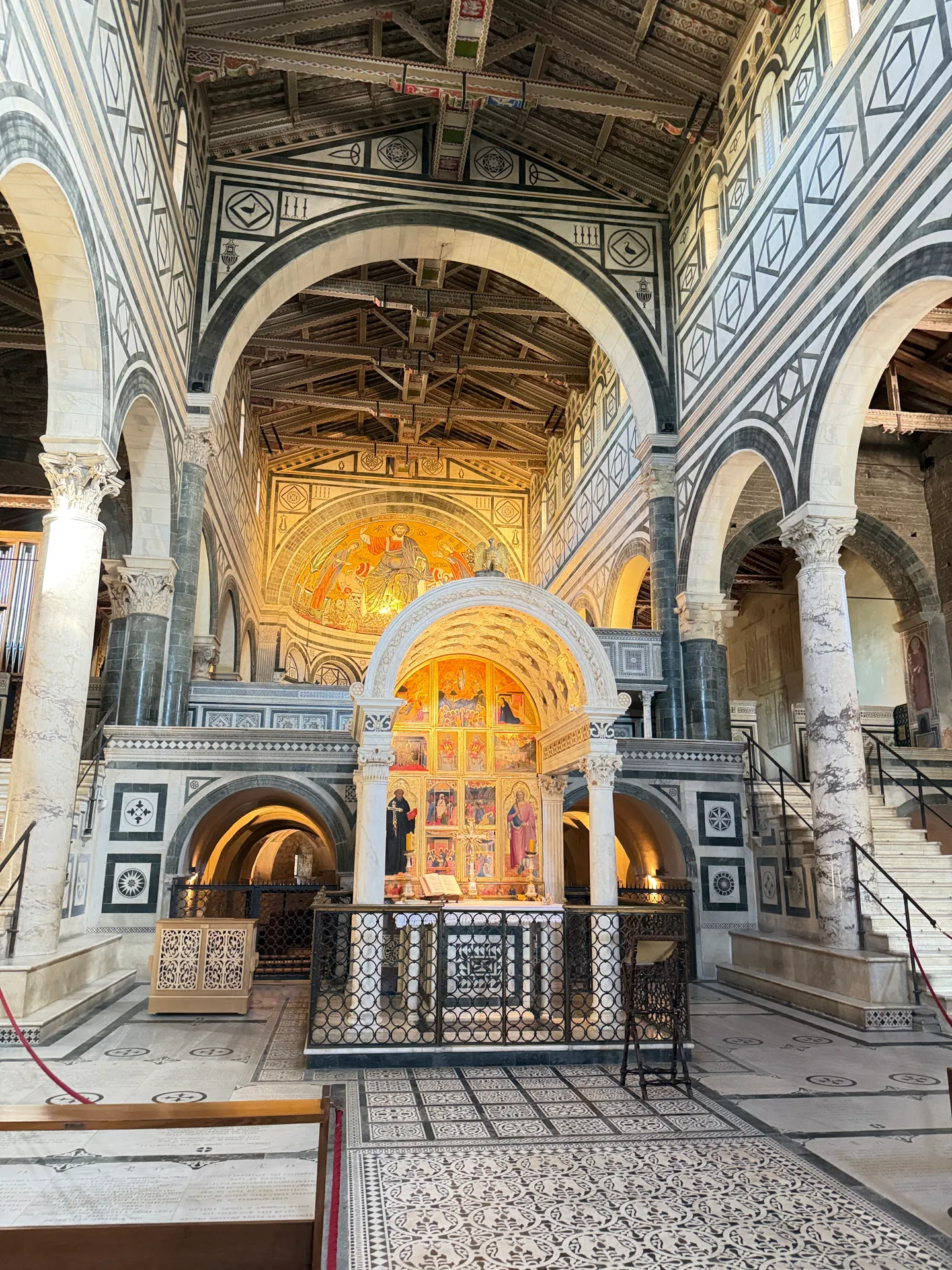 The east end of San Miniato: the marble choir screen, the Chapel of the Crucifix and the apse mosaic above.