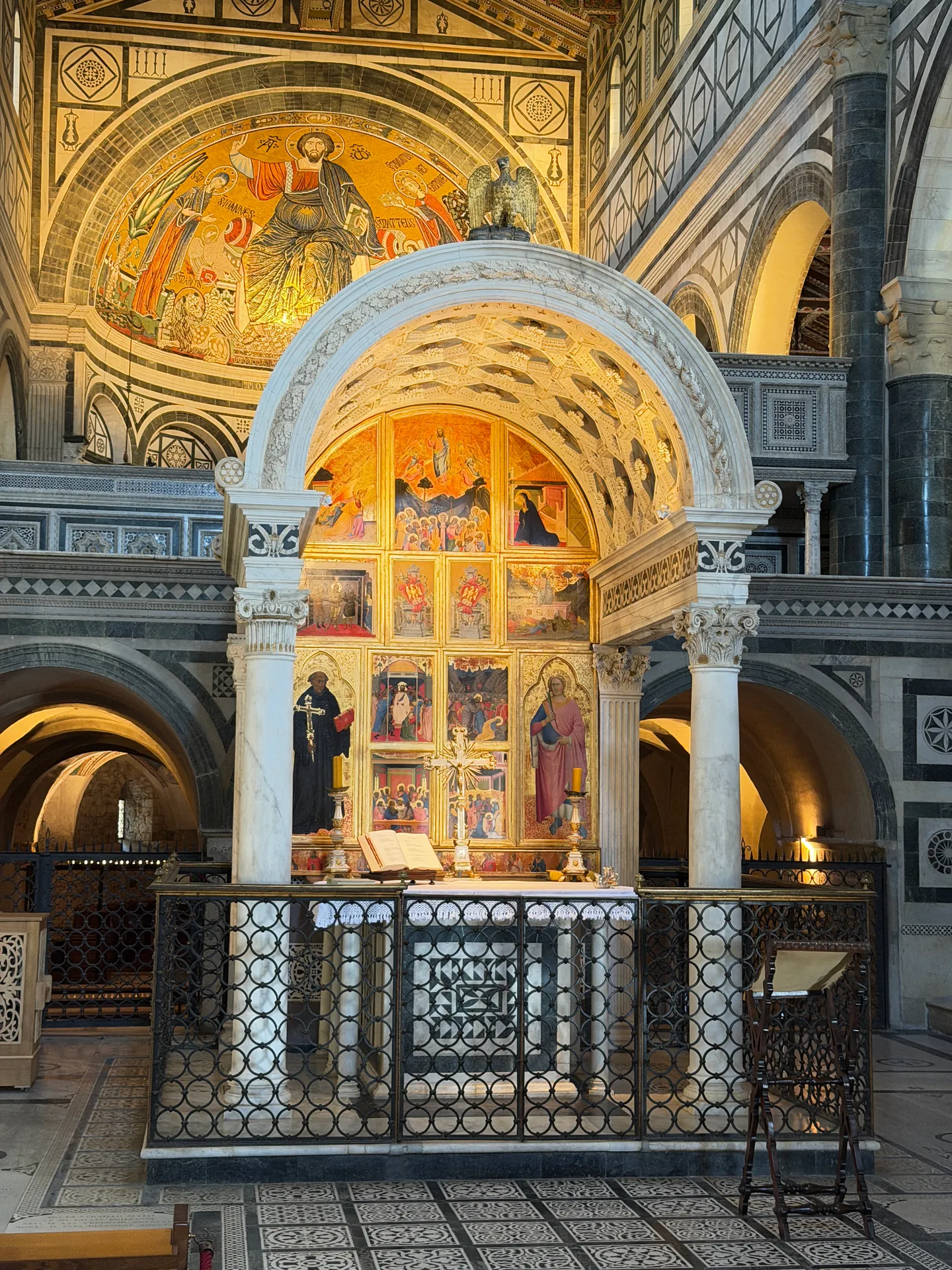 A gilded polyptych in the Chapel of the Crucifix, John Gualbert in his black habit at left, Minias with his palm at right.