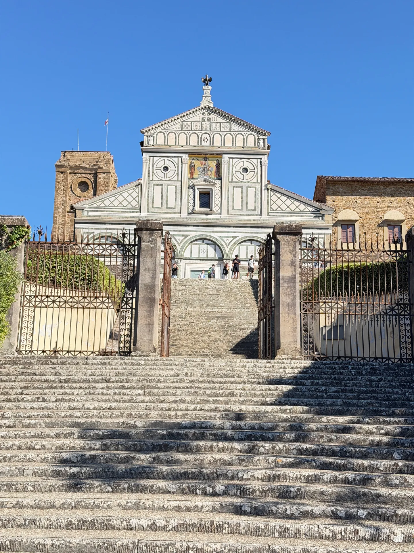 The great stair climbing to the gate piers below San Miniato al Monte, in deep raking shadow.