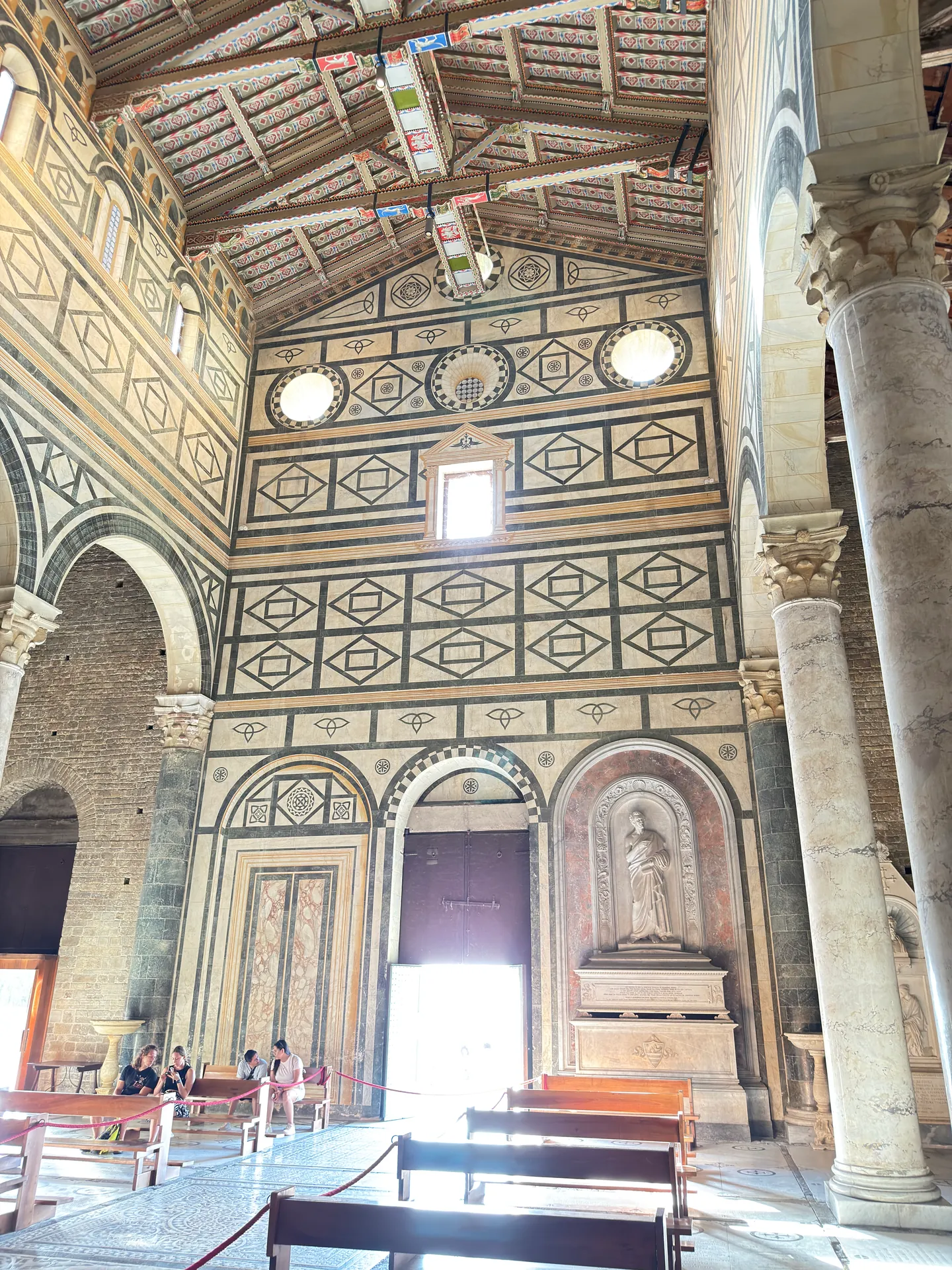 The inside of San Miniato's west wall, faced in green and white marble intarsia.