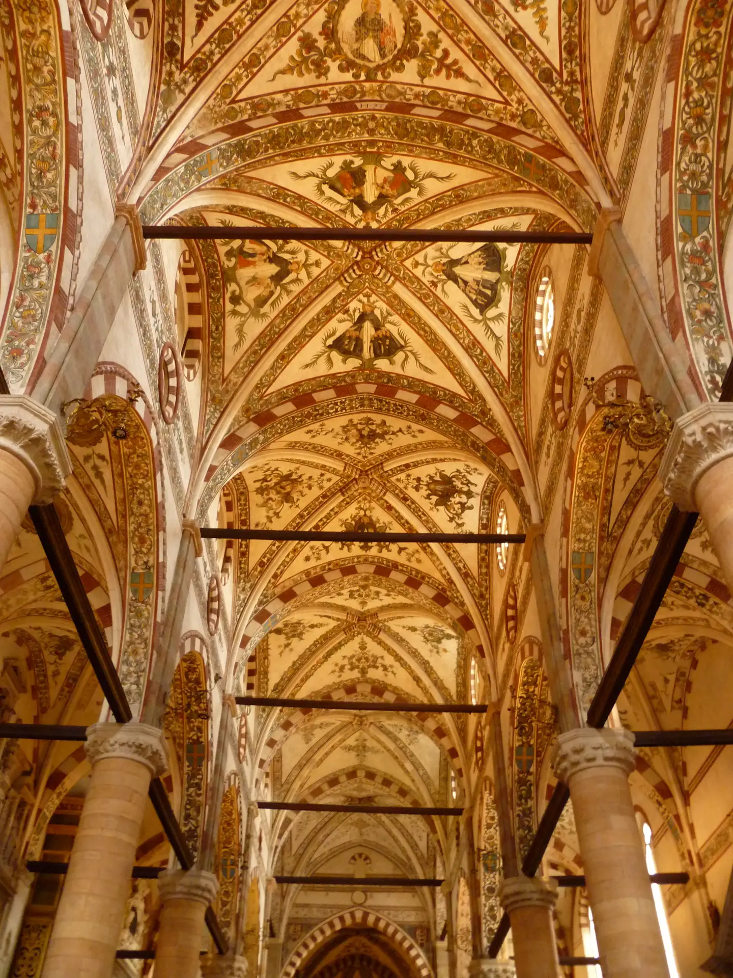 Marble columns and painted vaulting running the length of Santa Anastasia in Verona