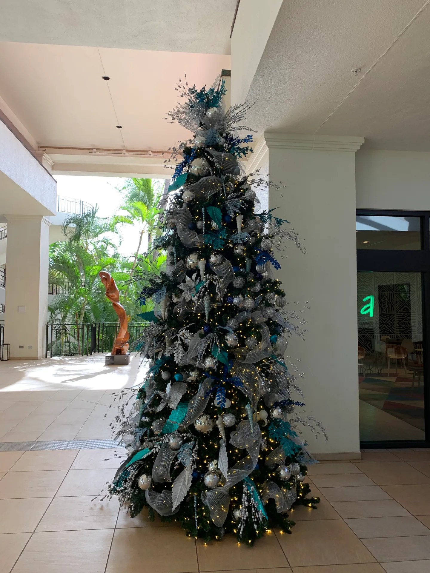 Decorated holiday tree in a bright open resort lobby