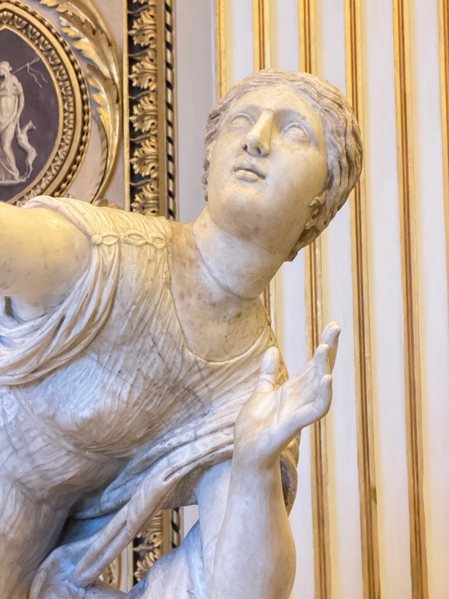 The head and shoulders of a daughter of Niobe turned upward, close.