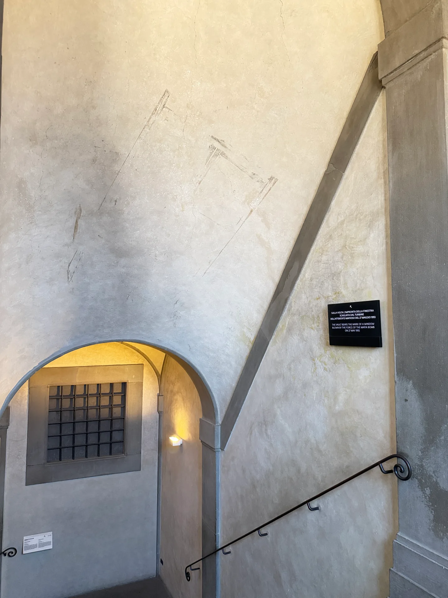 A stairwell vault in the Uffizi carrying the pale outline of a window shape in its plaster.