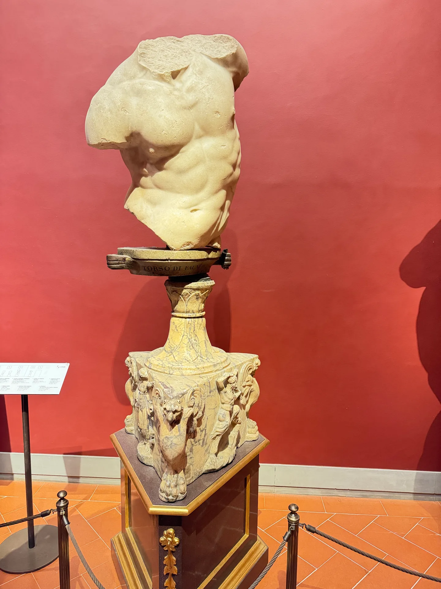 A fragmentary Roman marble torso set on an antique carved base.