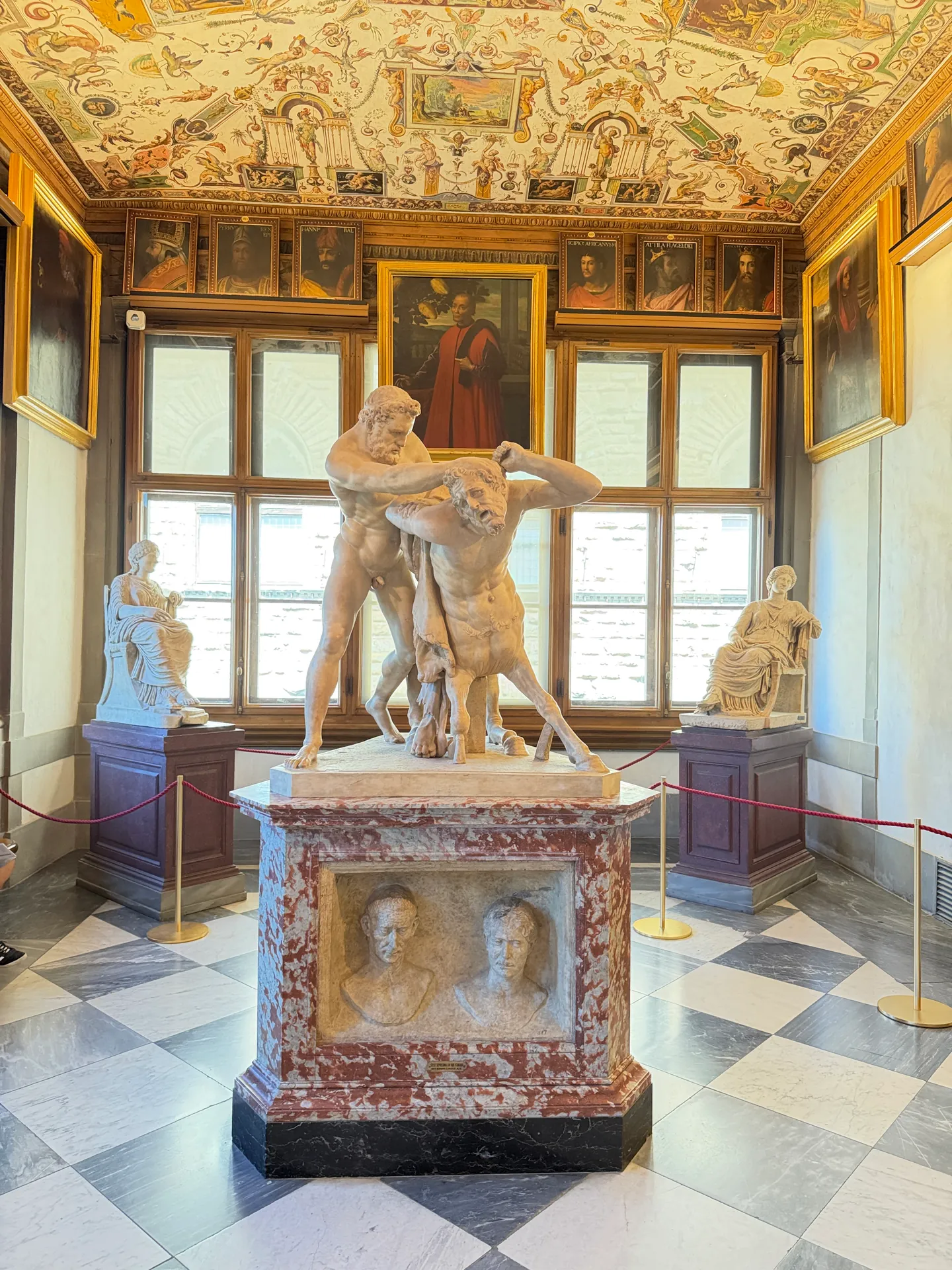 The head of the first corridor, the Hercules and Nessus group below a grotesque painted ceiling, marbles either side.