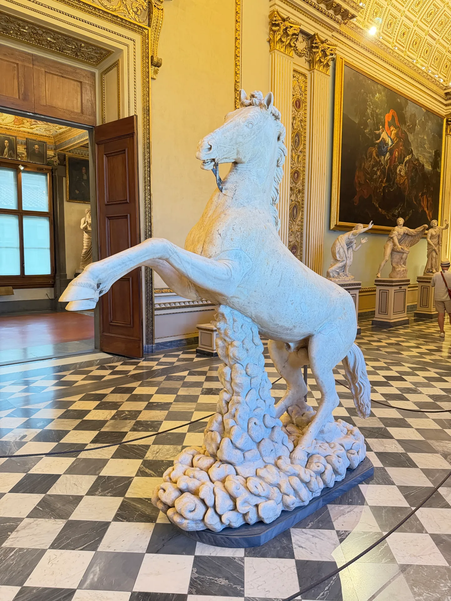 The antique marble horse in the Sala della Niobe, reared up on a rocky base by its sixteenth century restorer.