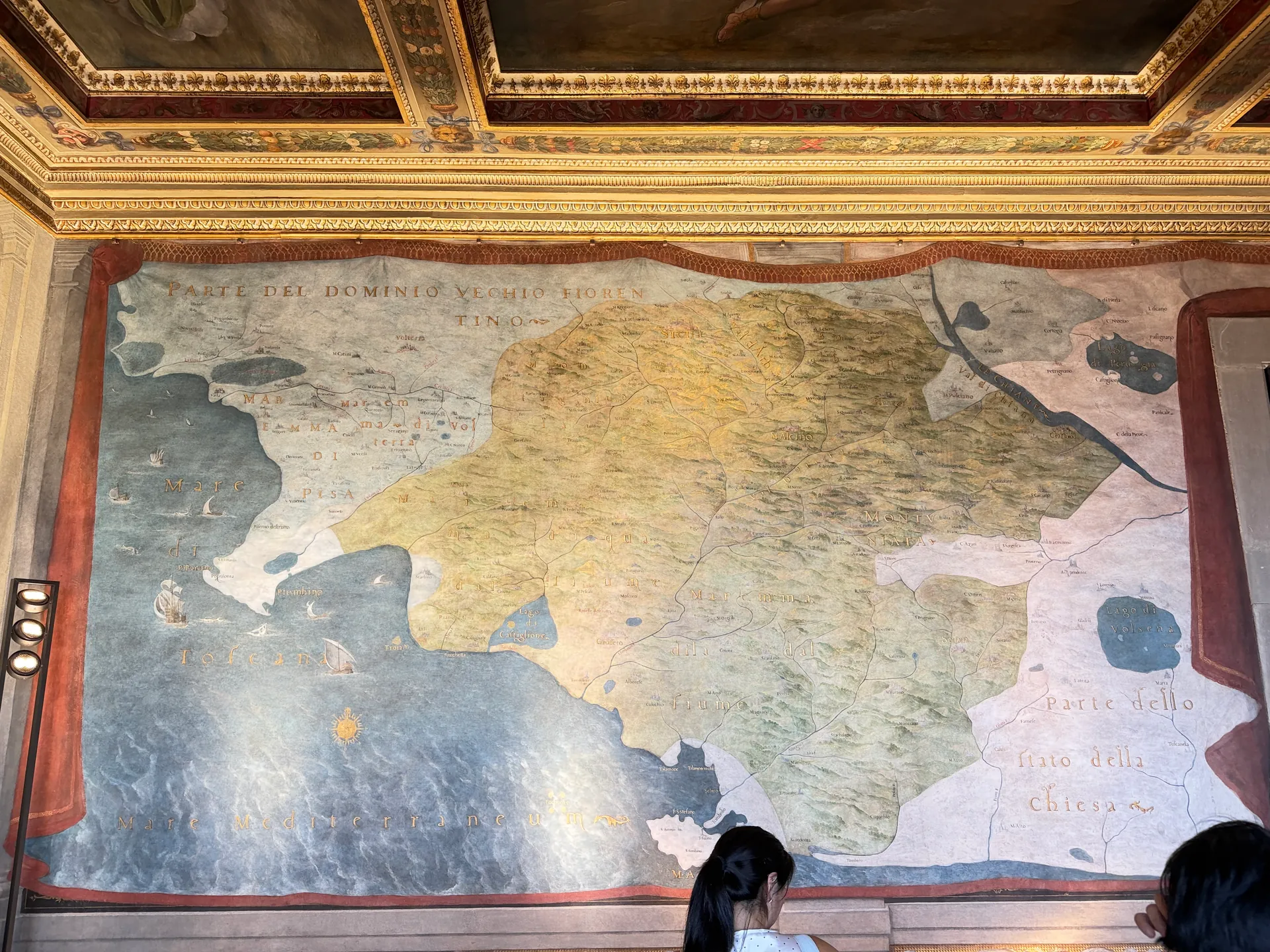 Frescoed wall maps in the Sala delle Carte Geografiche, painted canvases set into the ceiling above them.