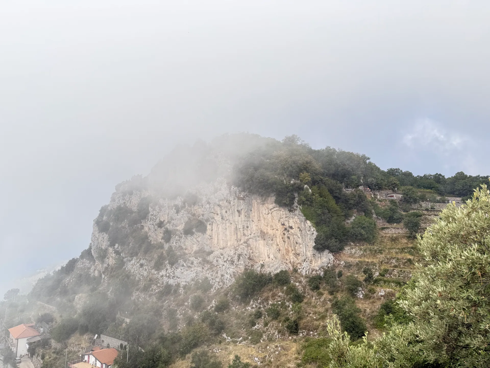 A limestone crag rising out of cloud that has filled the ground beneath it