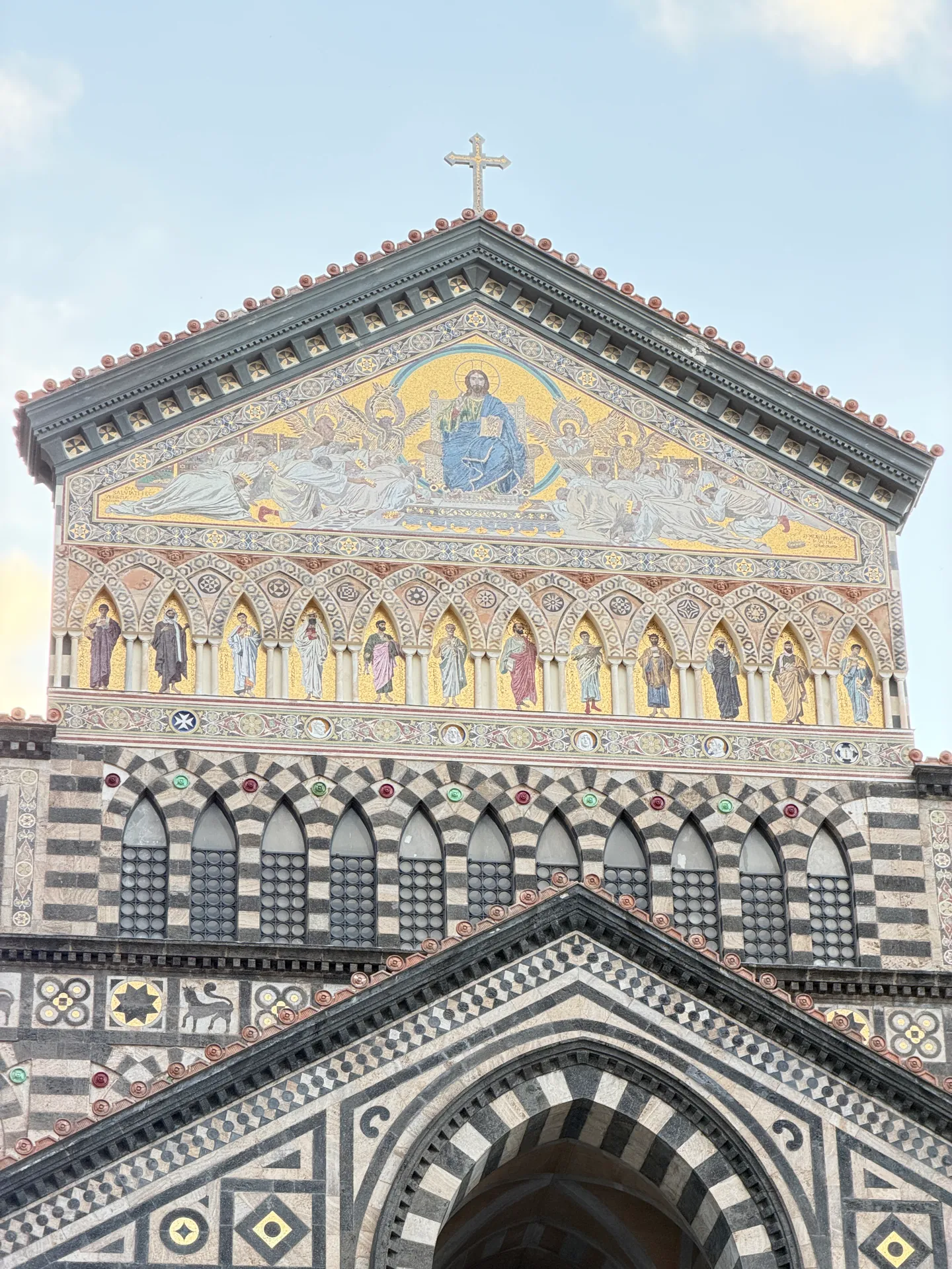 Gold mosaic in the pediment of Amalfi cathedral, a seated figure among angels above a row of apostles in arches