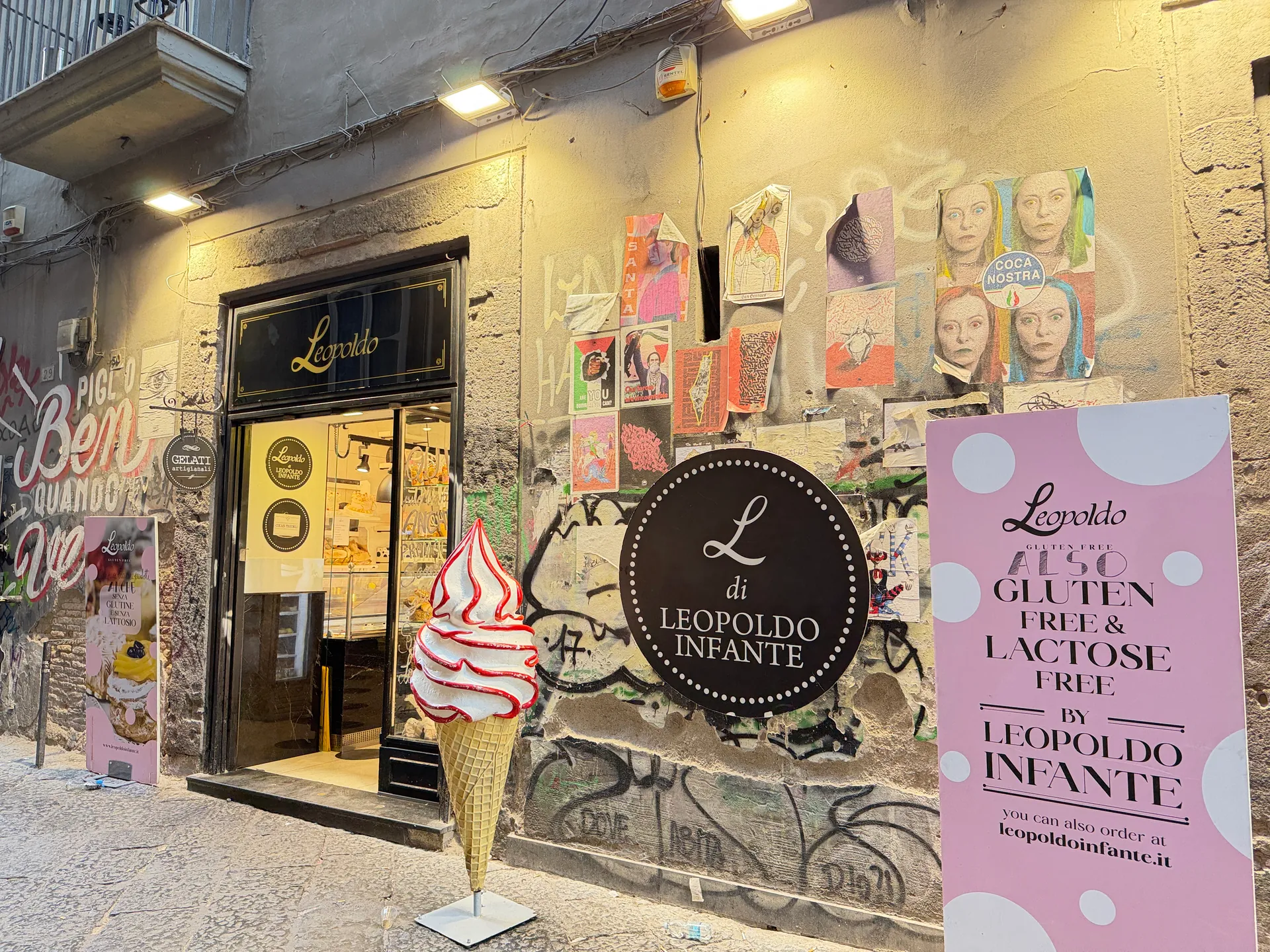 The Leopoldo Infante shopfront with banners on a lane in the old centre of Naples