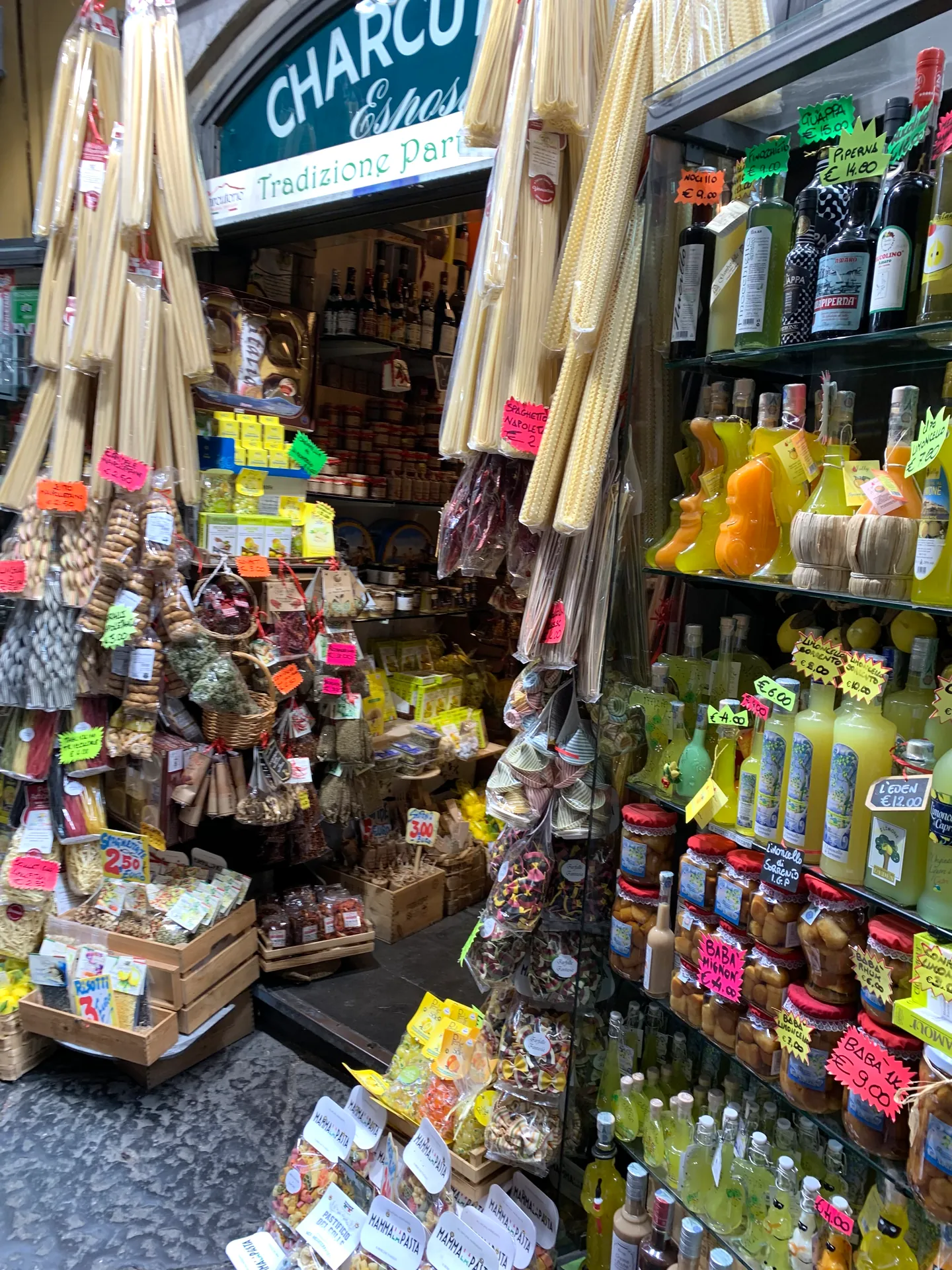 A shop packed with bottles and local produce in the historic centre of Naples