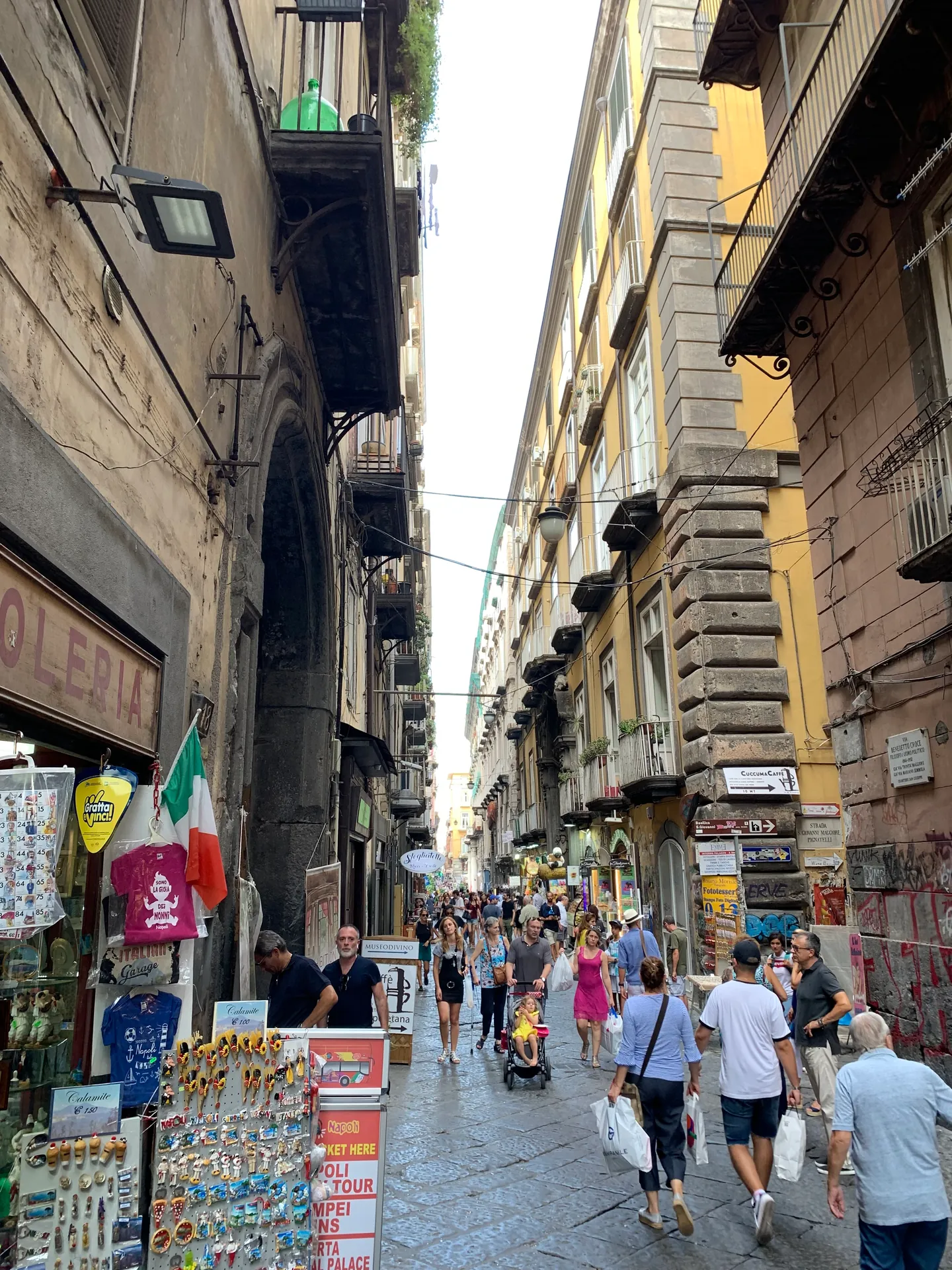A crowded street with stalls in the historic centre of Naples