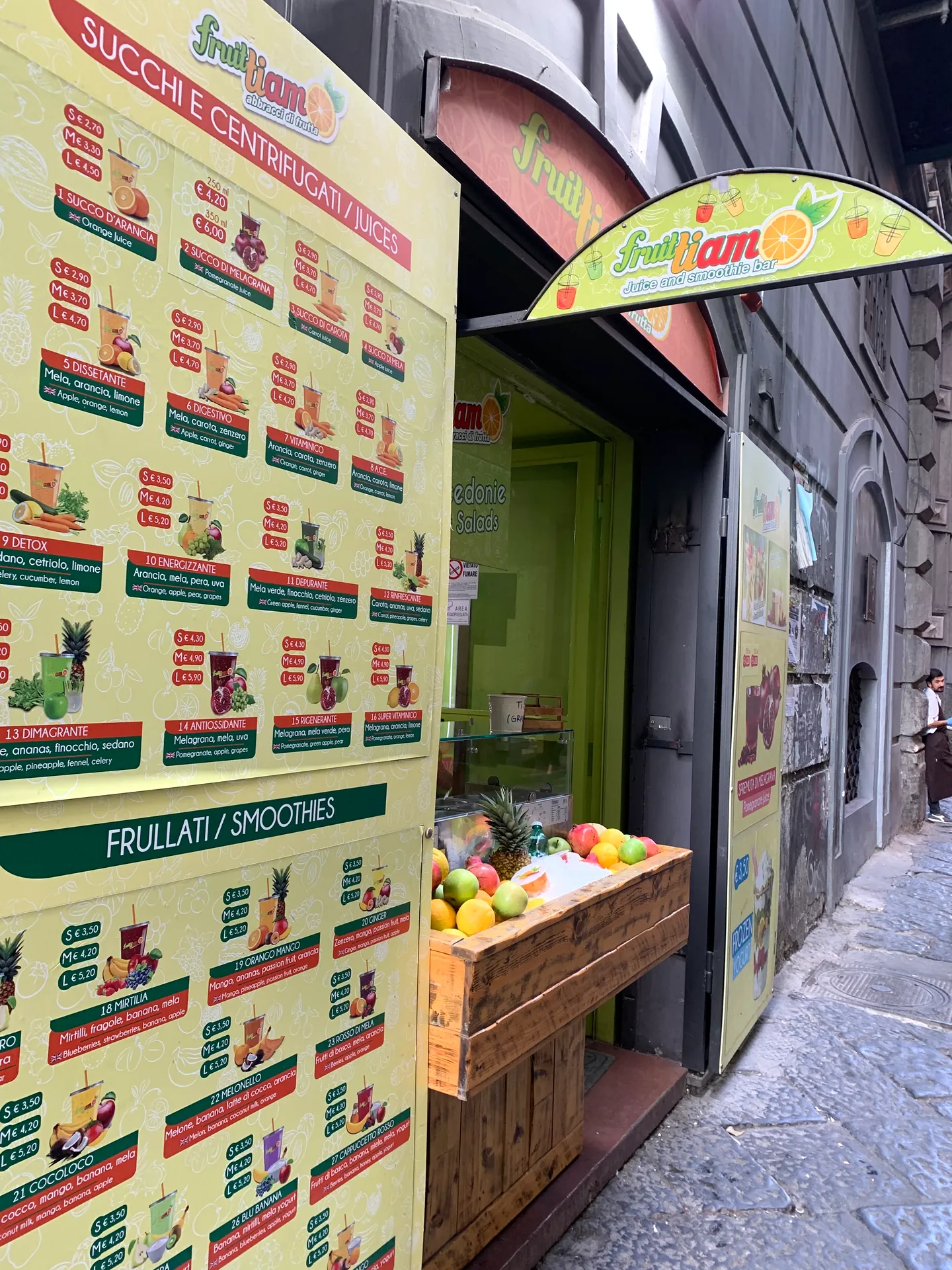 A juice and fruit stall in a doorway in the historic centre of Naples