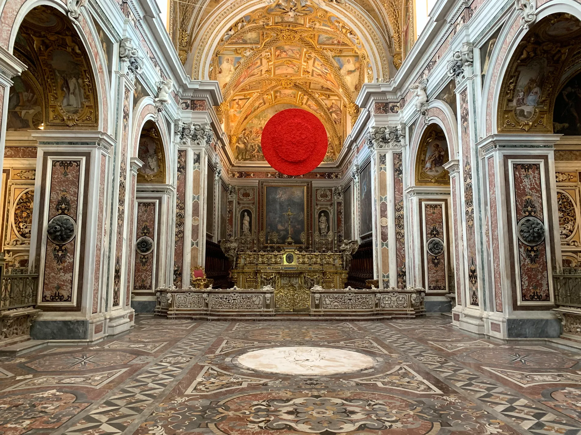 A baroque church interior with an inlaid marble floor in the historic centre of Naples