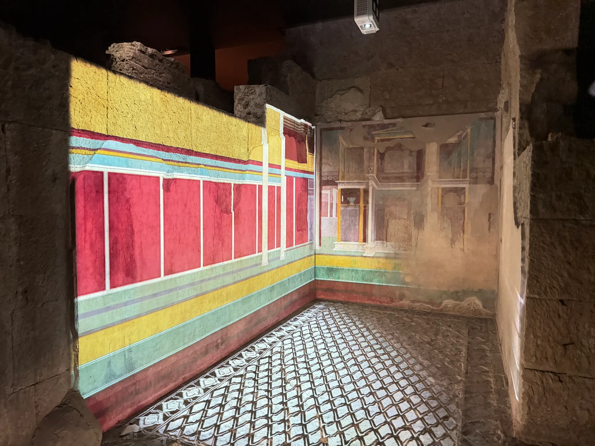 Projected reconstruction of wall painting and a lozenge floor filling a bare room, House of Augustus.